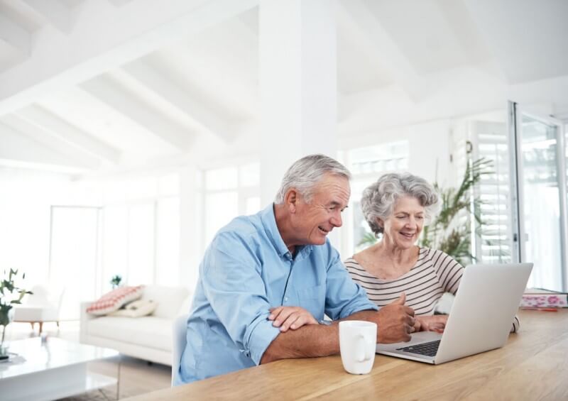Older couple in their home on the laptop