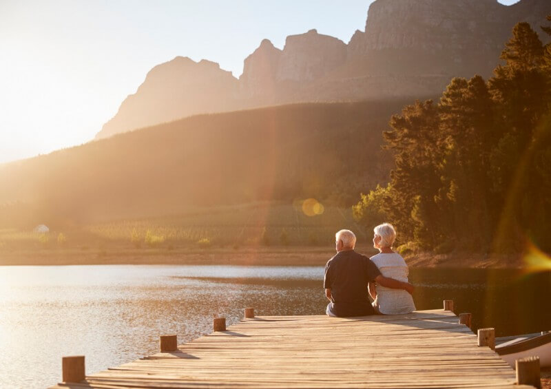 Older couple sat by a lake